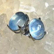 Blue gemstone earrings on a neutral background
