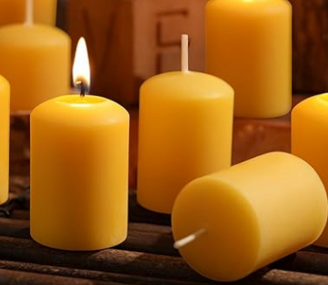 Multiple Candle Votive Beeswax one lit. Wooden background