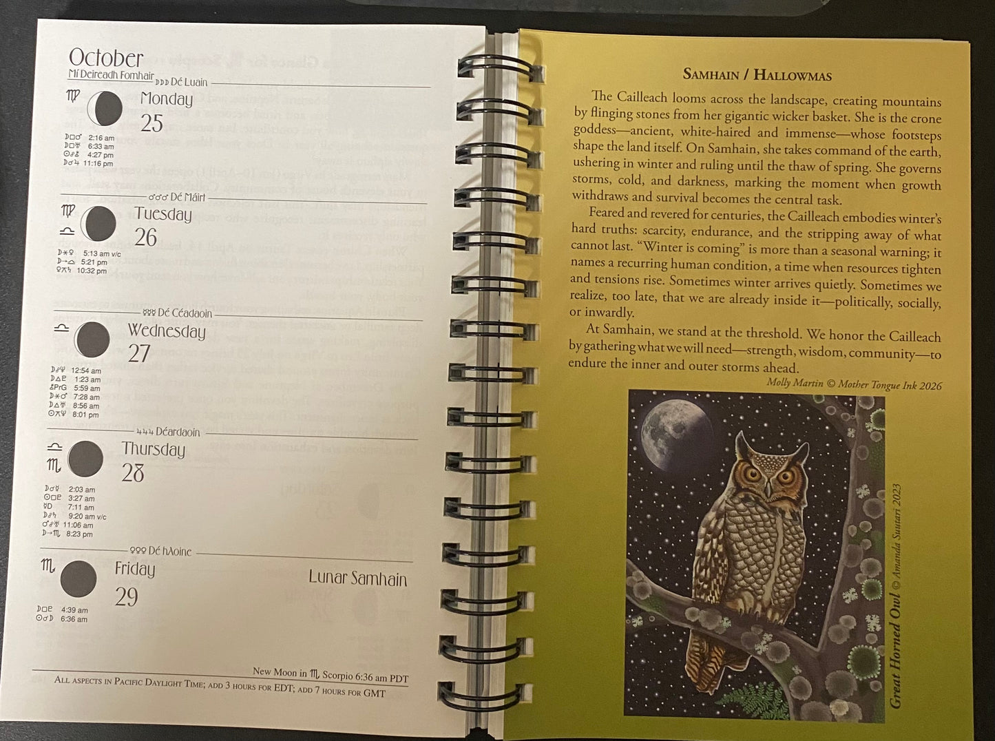 An open spiral-bound calendar or planner showing the October 2023 calendar spread, with a yellow cover page titled 'Sahasrā / HALLOWEEN' and occult-themed artwork of a moon on a skull.