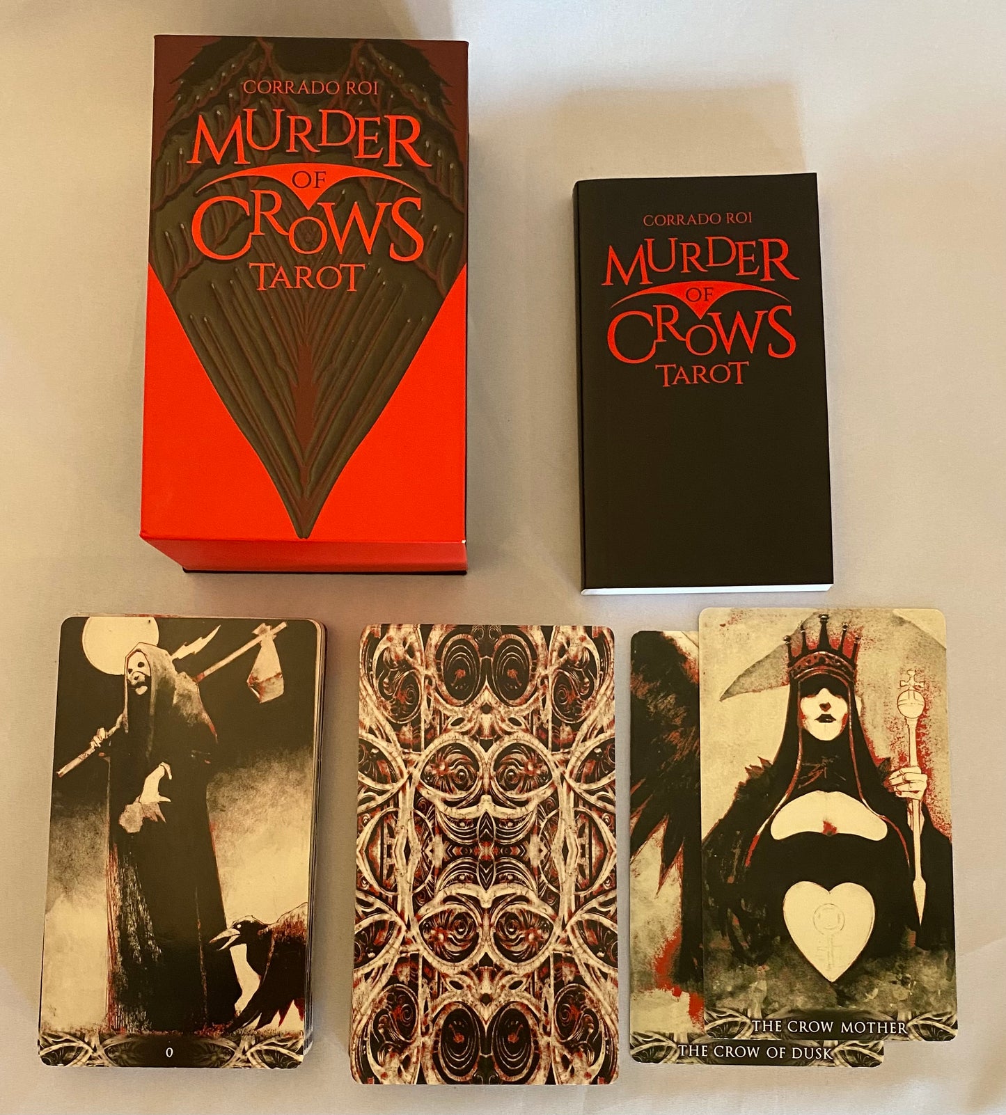 Gothic-themed 'Murder of Crows Tarot' set with tarot cards and packaging on a white background