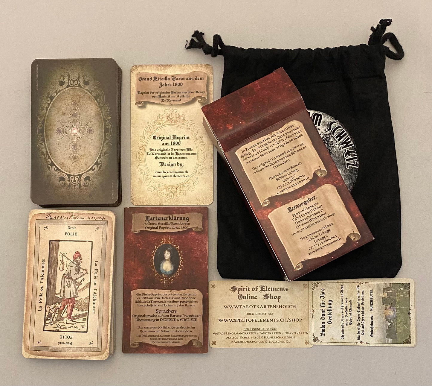 Collection of vintage-style cards with text and images, including a black drawstring bag.