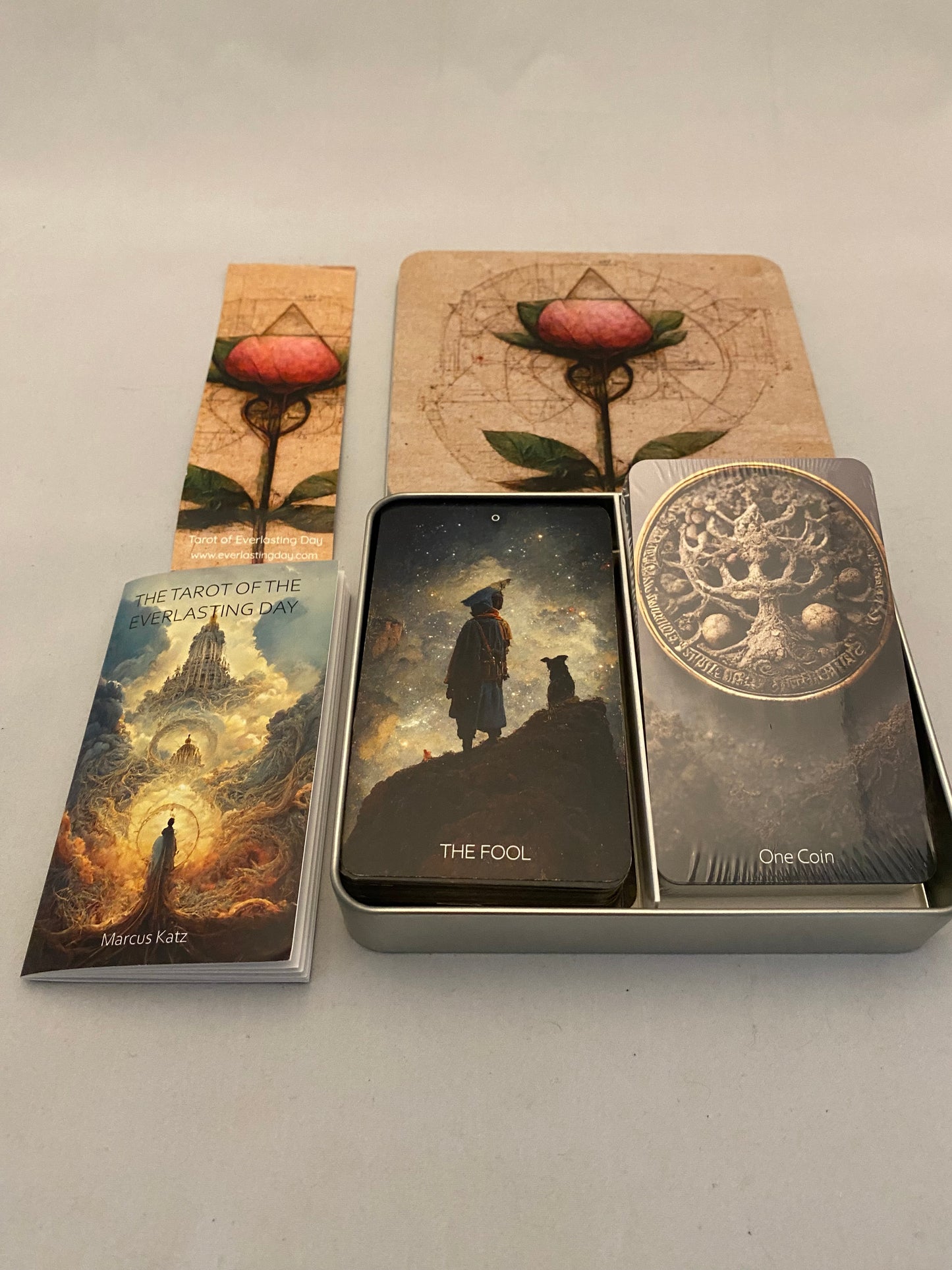 Collection of tarot cards in a metal box with artwork on the cover