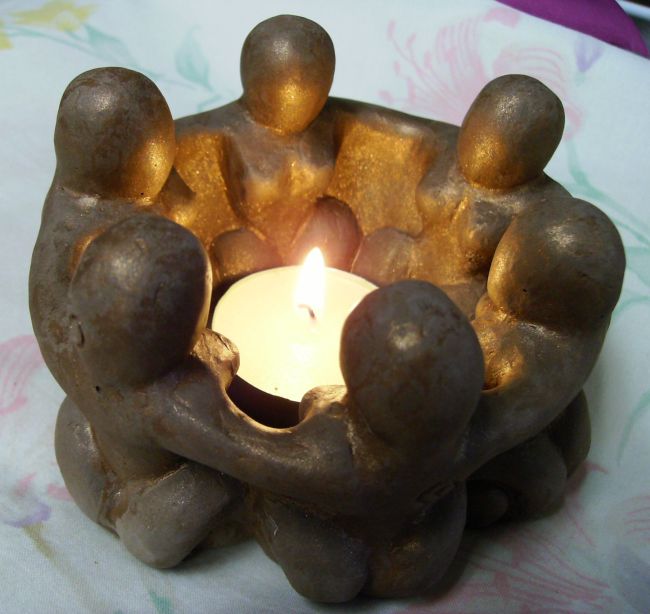 Circle of goddesses lit by a candle