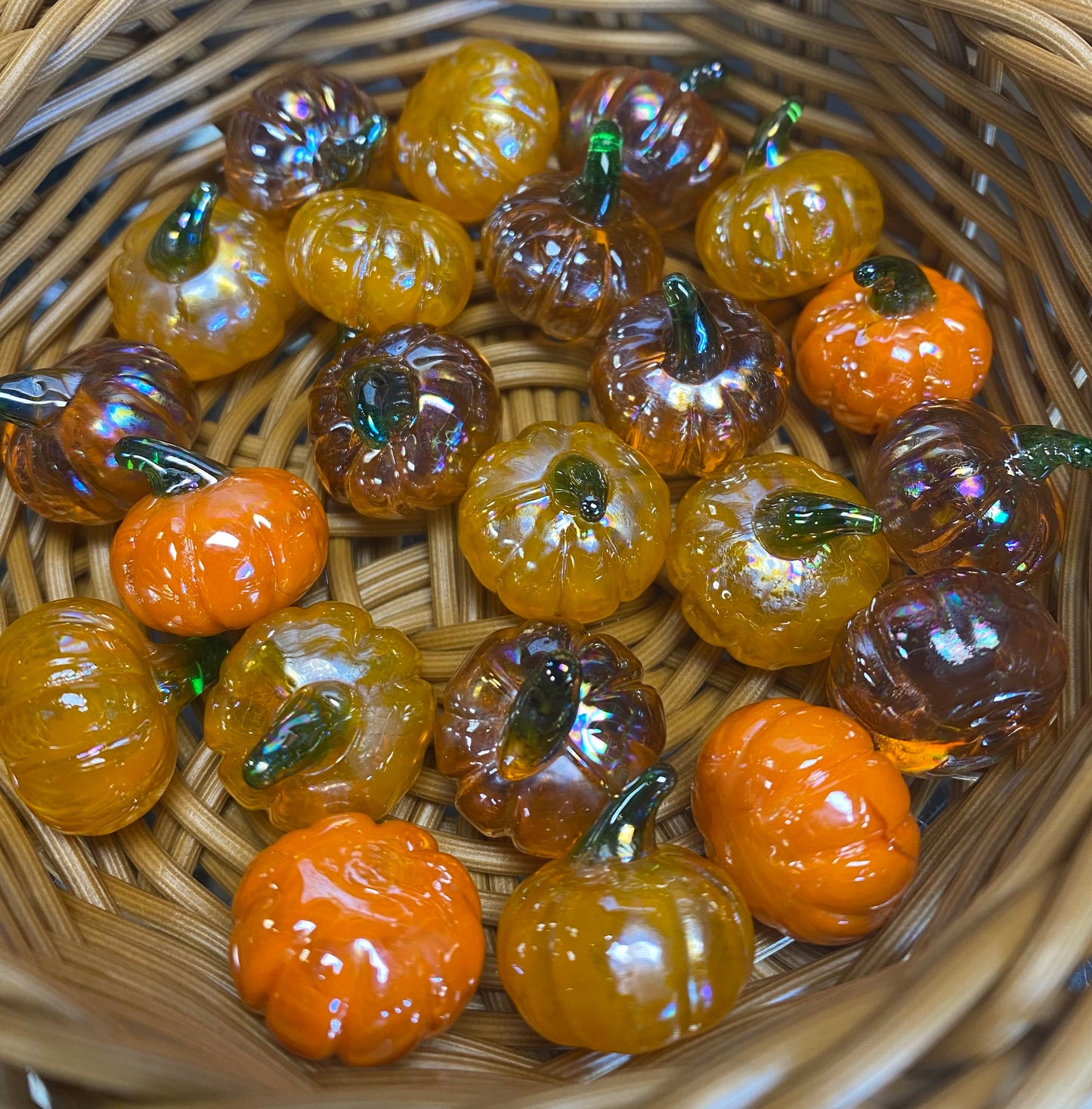 Pumpkin glass charms in a basket