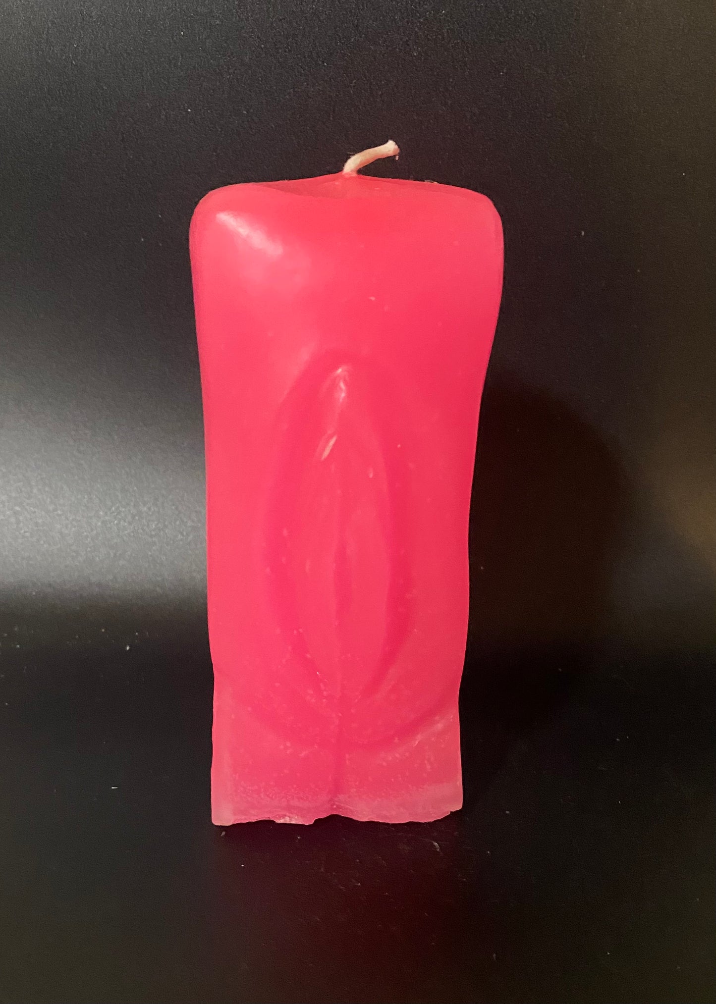 Pink candle on a black background