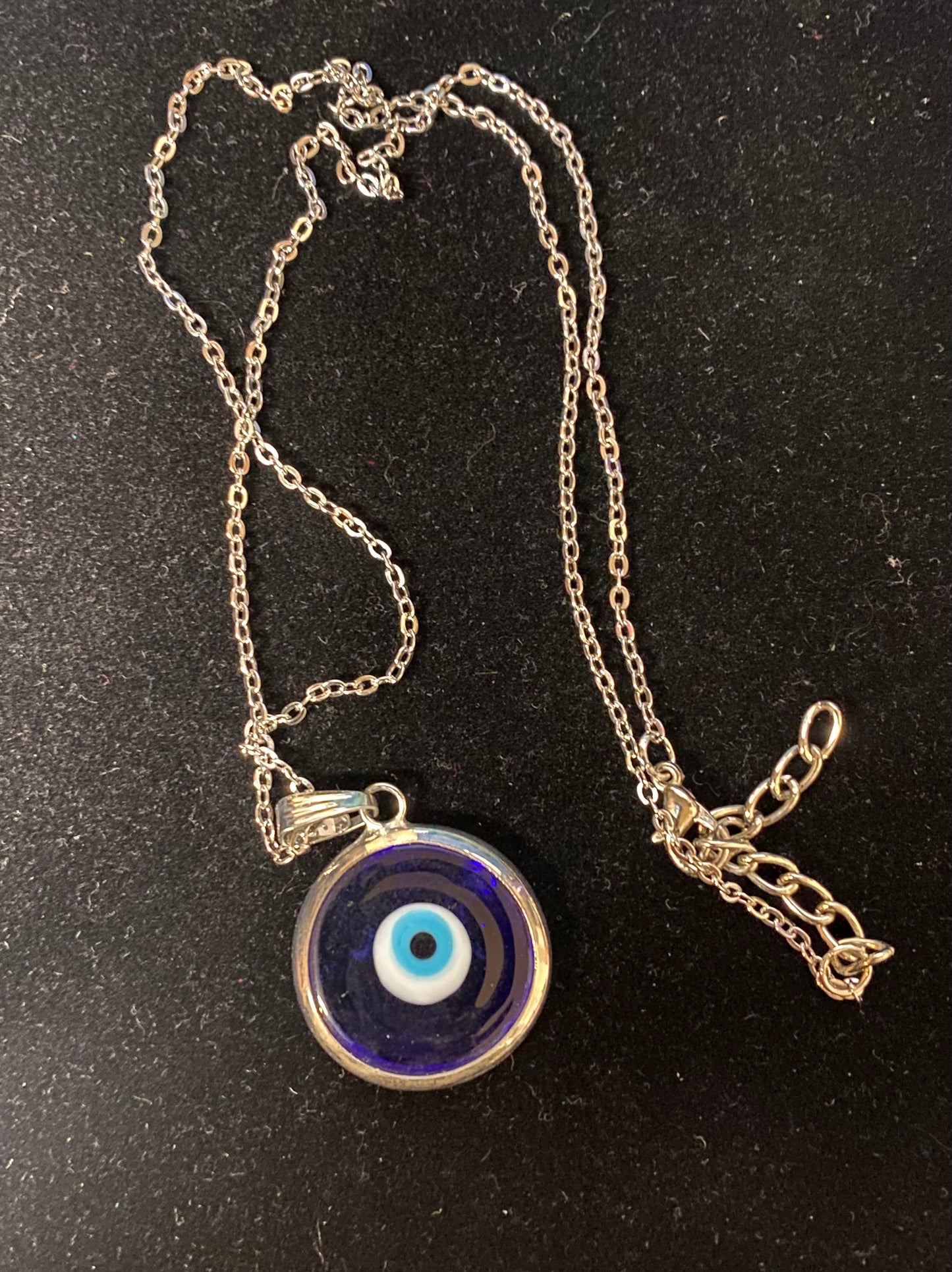 Necklace with an eye-shaped pendant on a black background