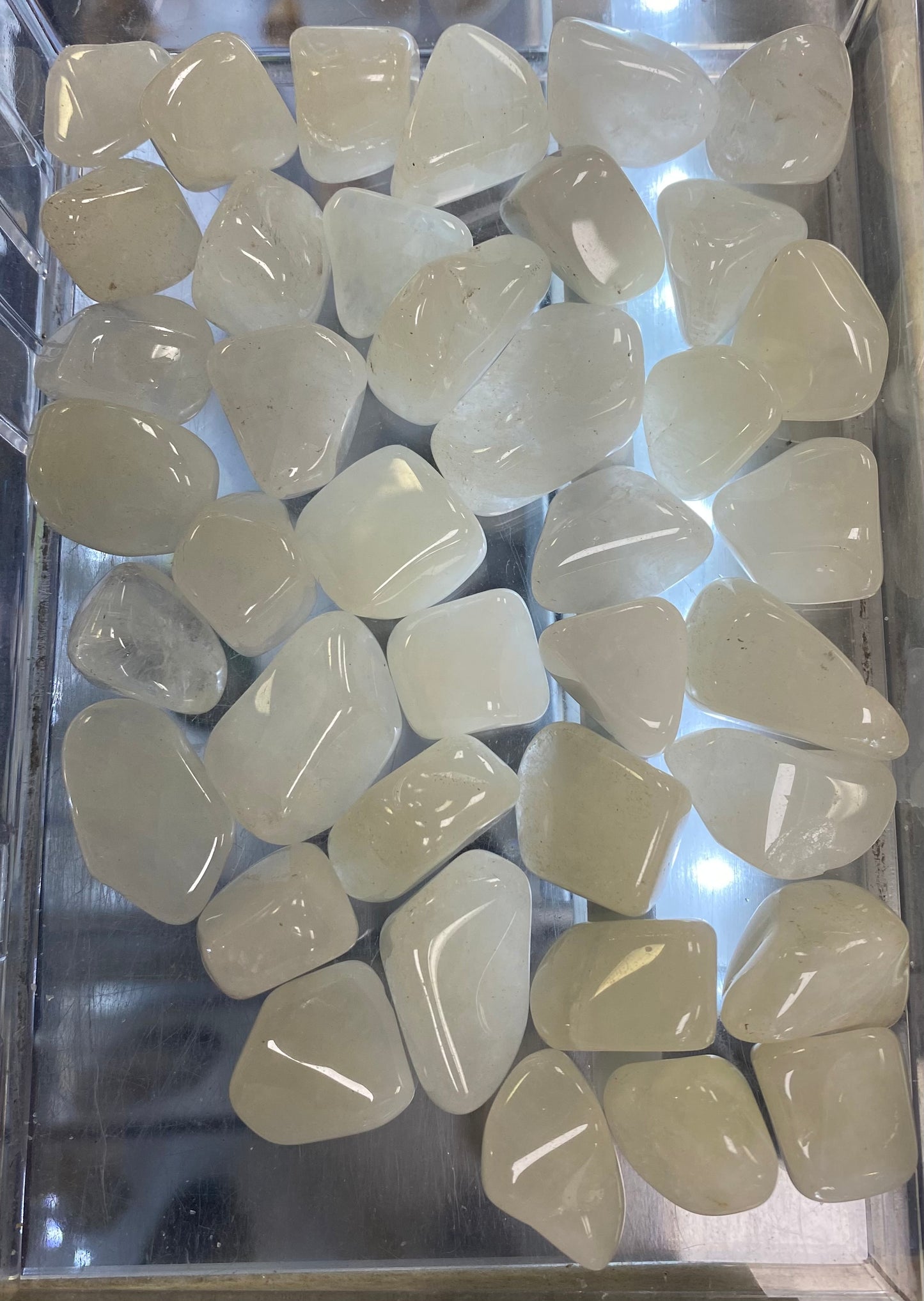 Collection of light-colored stones in a clear container