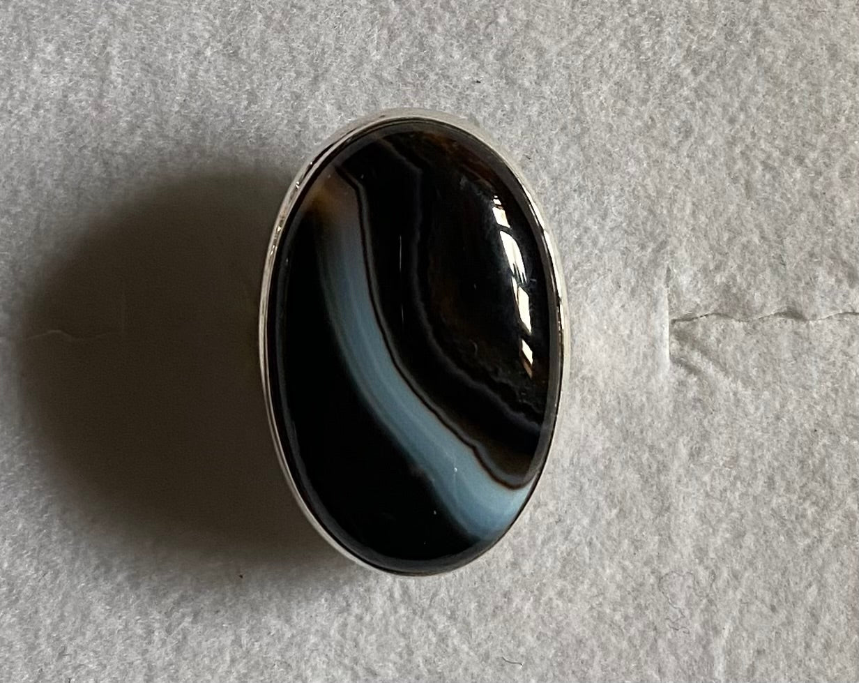 Black and gray agate stone on a light gray background