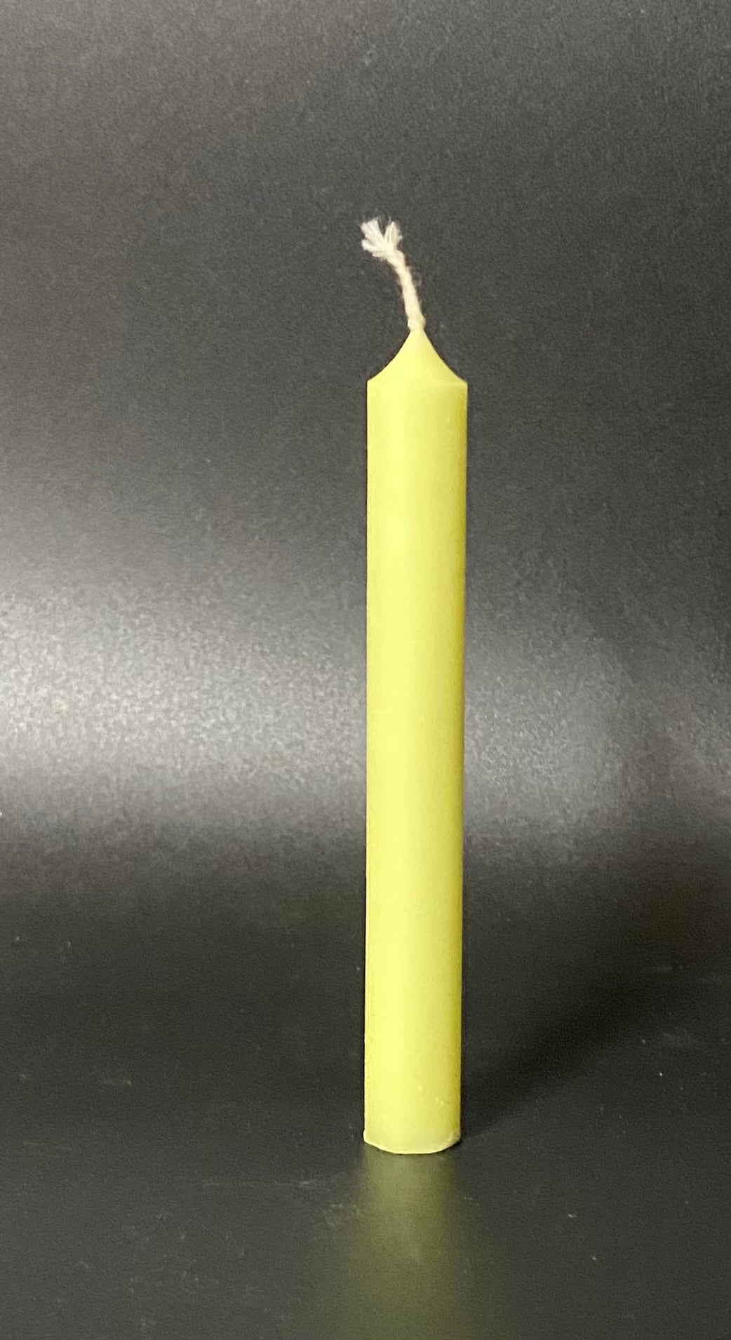 Yellow candle on a black background