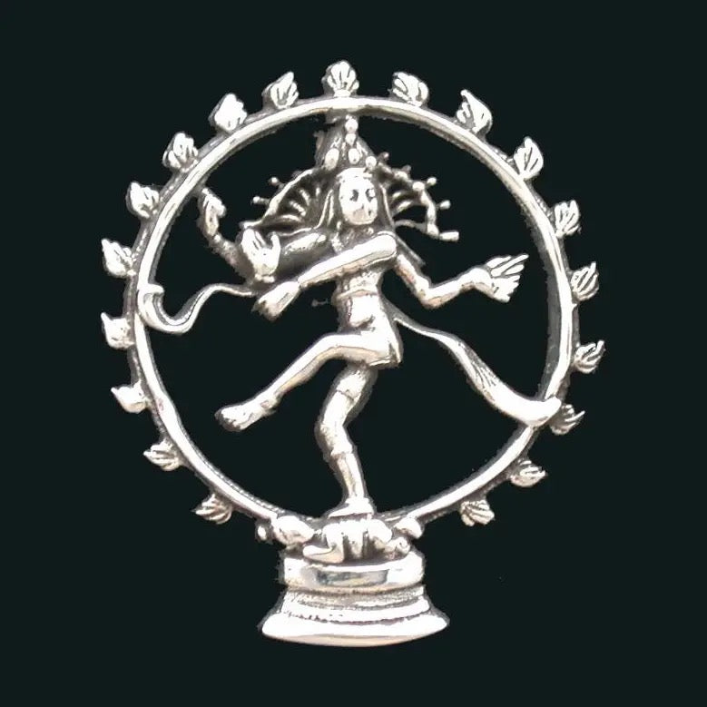 Silver statue of a dancer in a circular frame on a black background