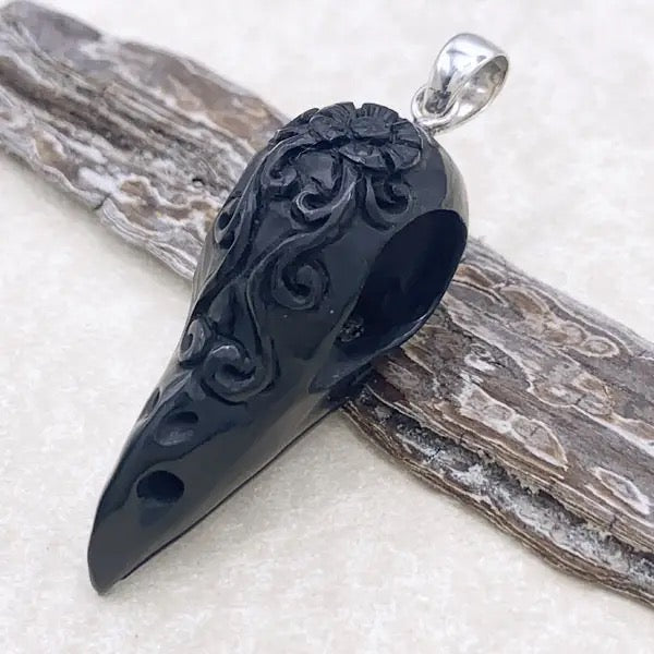 Black ornate pendant on a white background