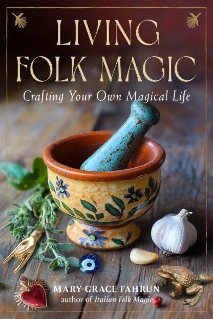 Book cover of 'Living Folk Magic' with a mortar and pestle, herbs, and garlic on a wooden surface.