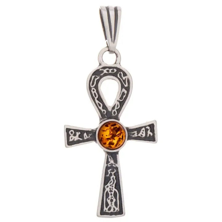 A sterling silver ankh pendant featuring intricate engravings and a central round amber gemstone, shown against a plain white background.