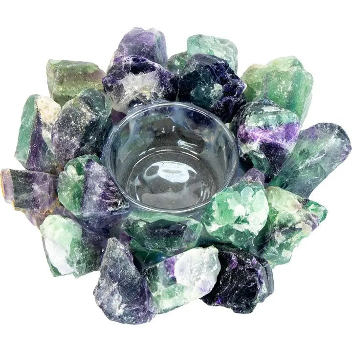 Tealight candle holder made of natural green and purple crystals on a white background