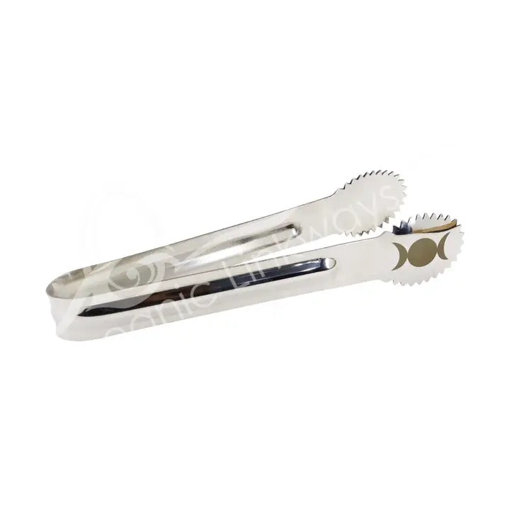 Metallic tongs with decorative design on a white background
