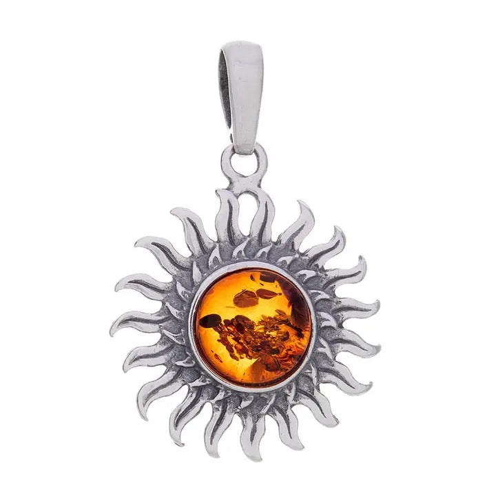 A sterling silver sun pendant featuring a round amber center, set against a plain white background.