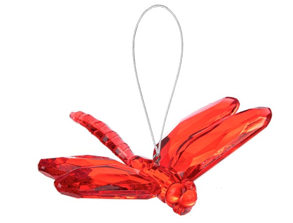 Red dragonfly-shaped ornament on a white background