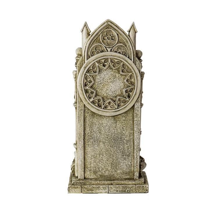 A gothic-style Santa Muerte decoration with intricate carved stone detailing, a circular rose window motif, and pointed arch top, shown on a plain white background.