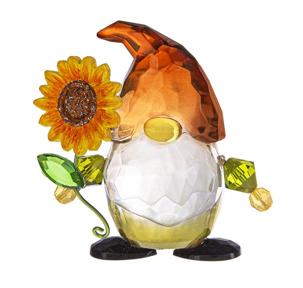 Glass gnome figurine with a sunflower on a white background