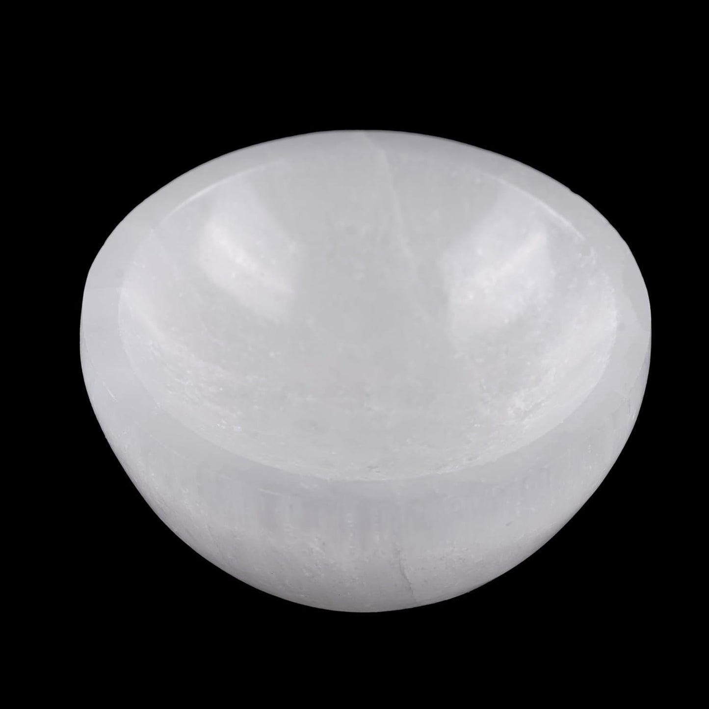 White selenite bowl on a black background