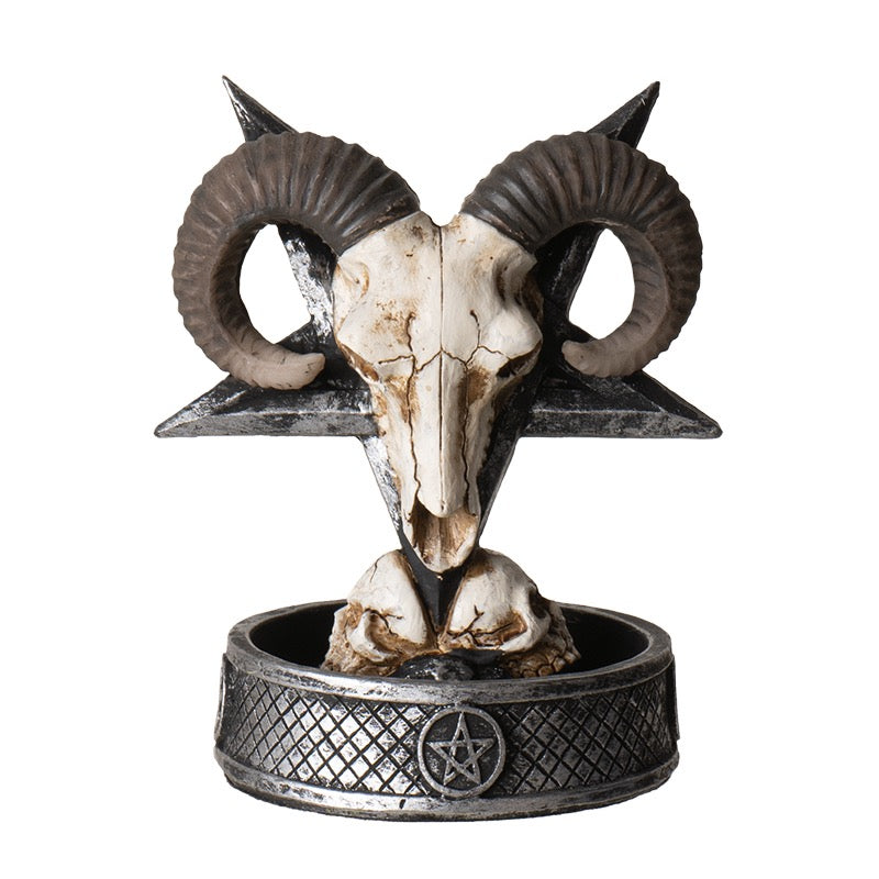 Decorative ram skull with horns on a pentagram base against a white background