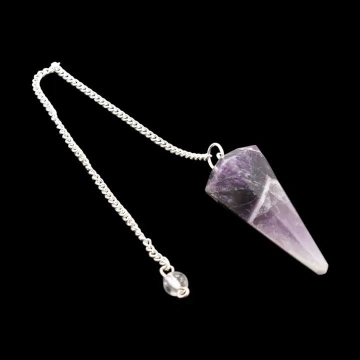 Amethyst crystal pendulum on a black background