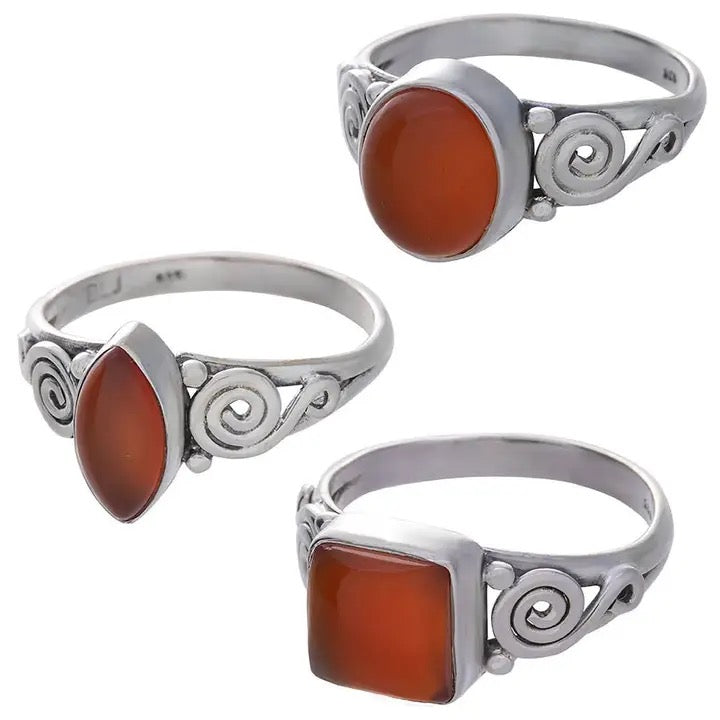 Three silver rings with brown stone inlays on a white background