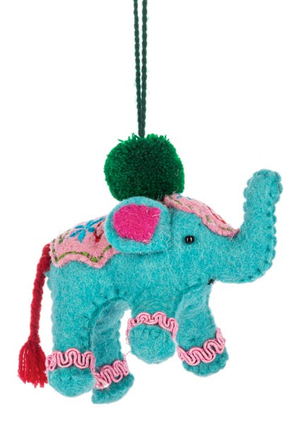 Decorative elephant ornament with teal body, pink accents, and green pom-pom on a white background