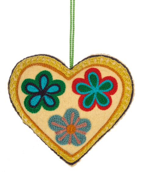 Heart-shaped ornament with floral designs on a white background