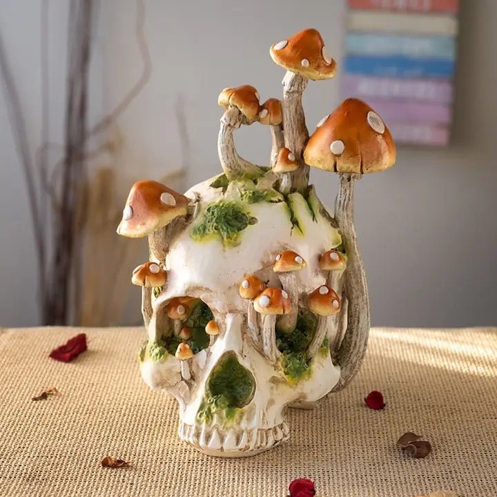 Decorative skull with mushroom design on a textured surface