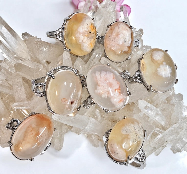 Assorted Rings Flower Agate Stainless Steel on a quartz crystal