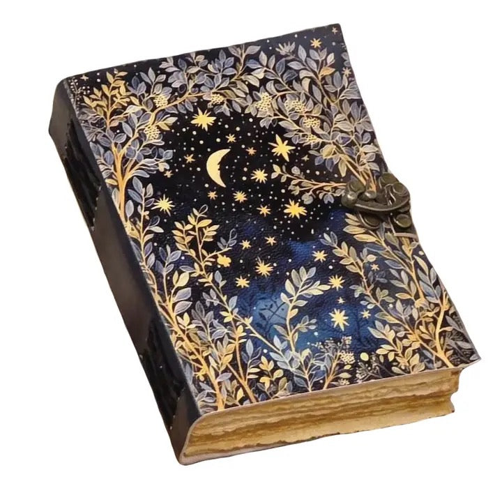 A Leather journal with a dark navy blue cover decorated with gold and silver botanical patterns, stars, and a crescent moon, featuring a metal clasp closure.