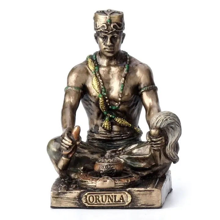 Statue of a seated figure with 'Orunla' inscription on a white background