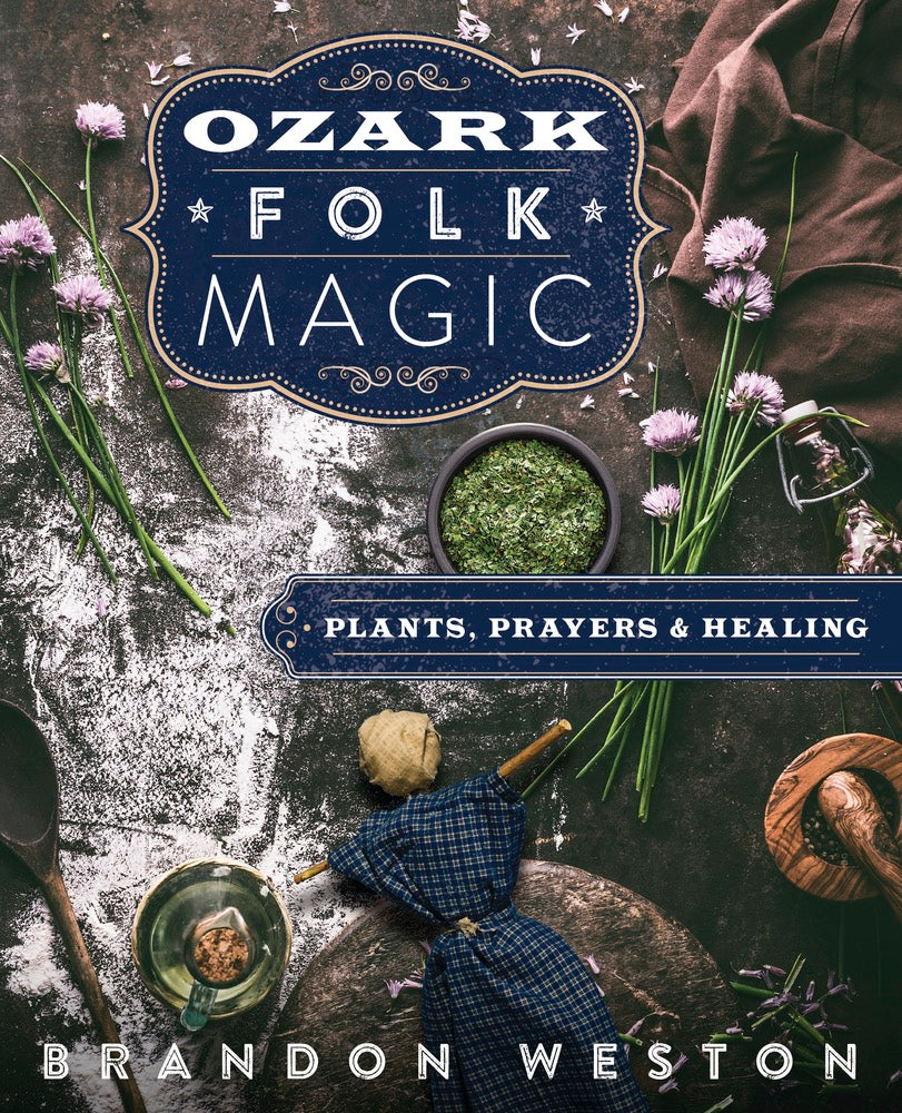 Book cover of 'Ozark Folk Magic' by Brandon Weston with herbs, a doll, and other elements on a dark background.
