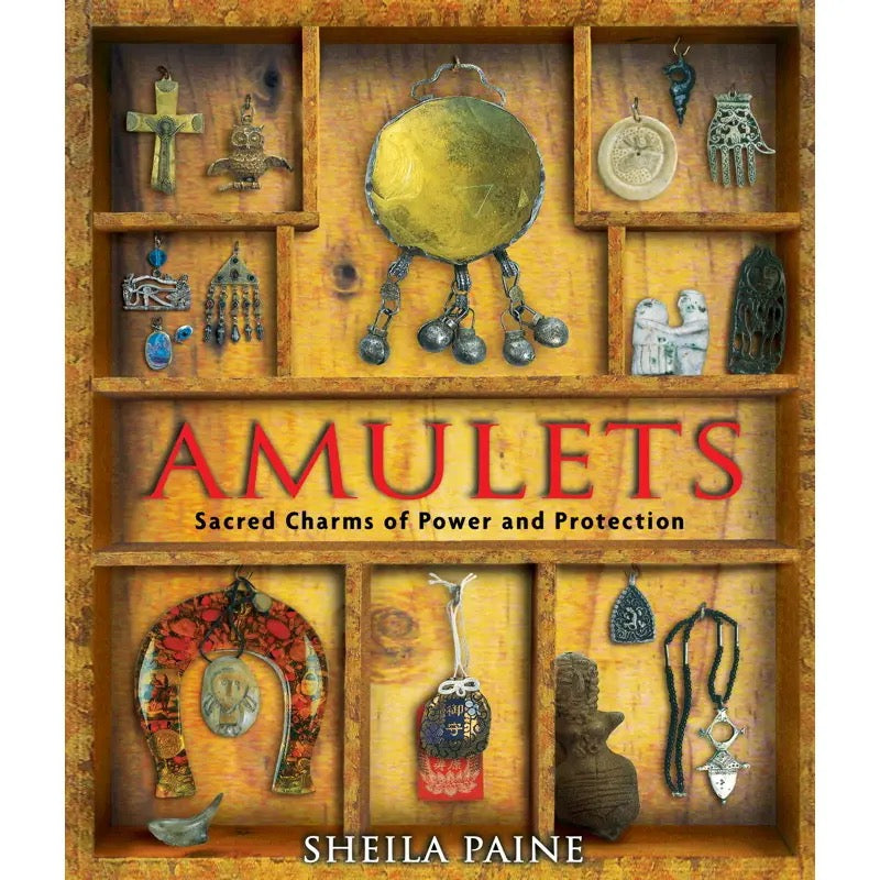 Book cover of 'Amulets: Sacred Charms of Power and Protection' by Sheila Paine, featuring various amulets in a wooden display case.