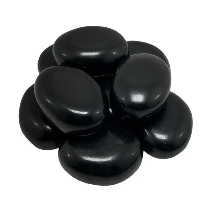 Black stones stacked on a white background