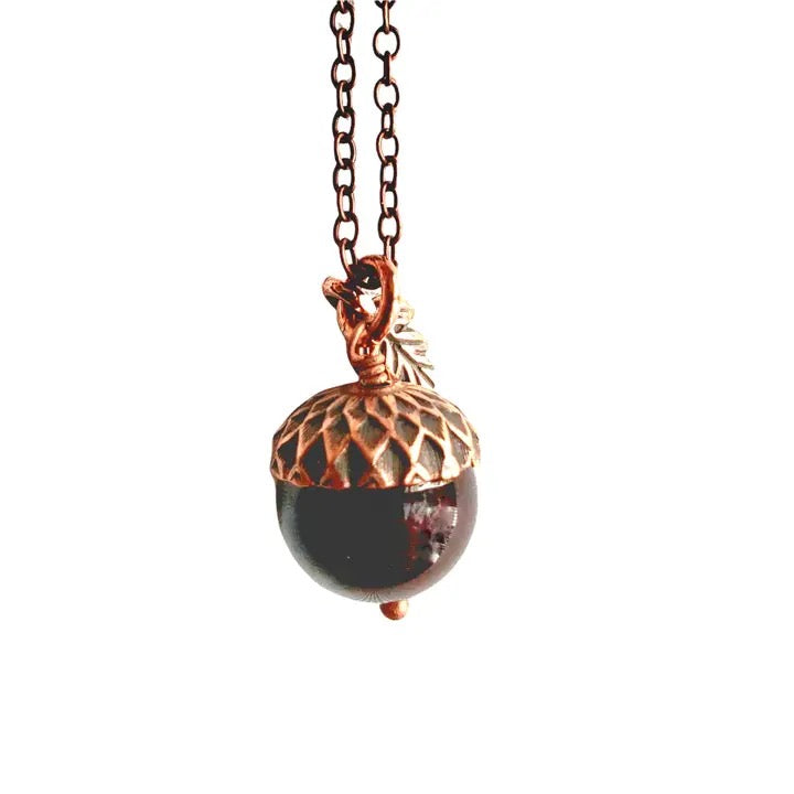 Necklace with a copper acorn pendant on a white background