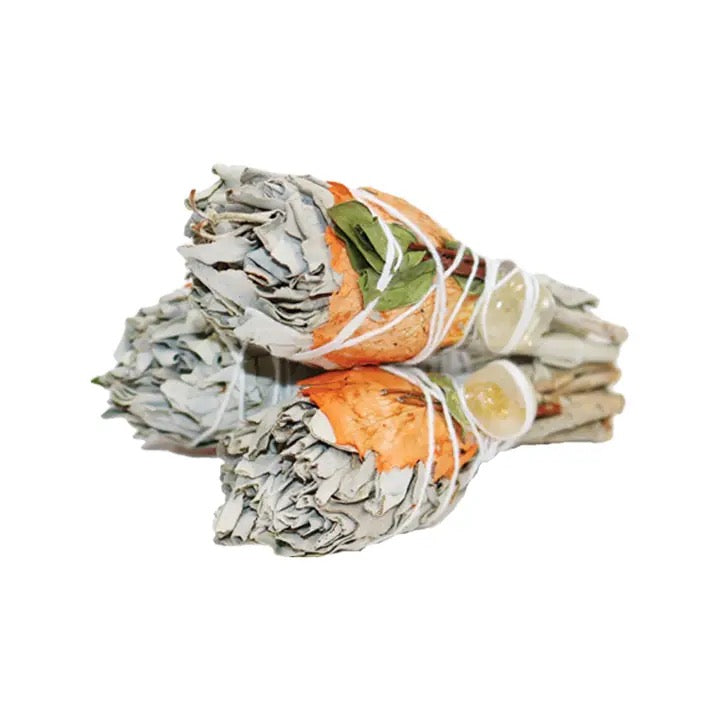 Three bundles of sage on a white background