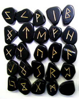 Set of black stones with gold Runes on a white background