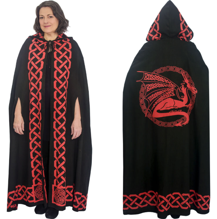 A black hooded cape with red Celtic knot trim and a large red dragon graphic on the back, shown on a model against a white background.