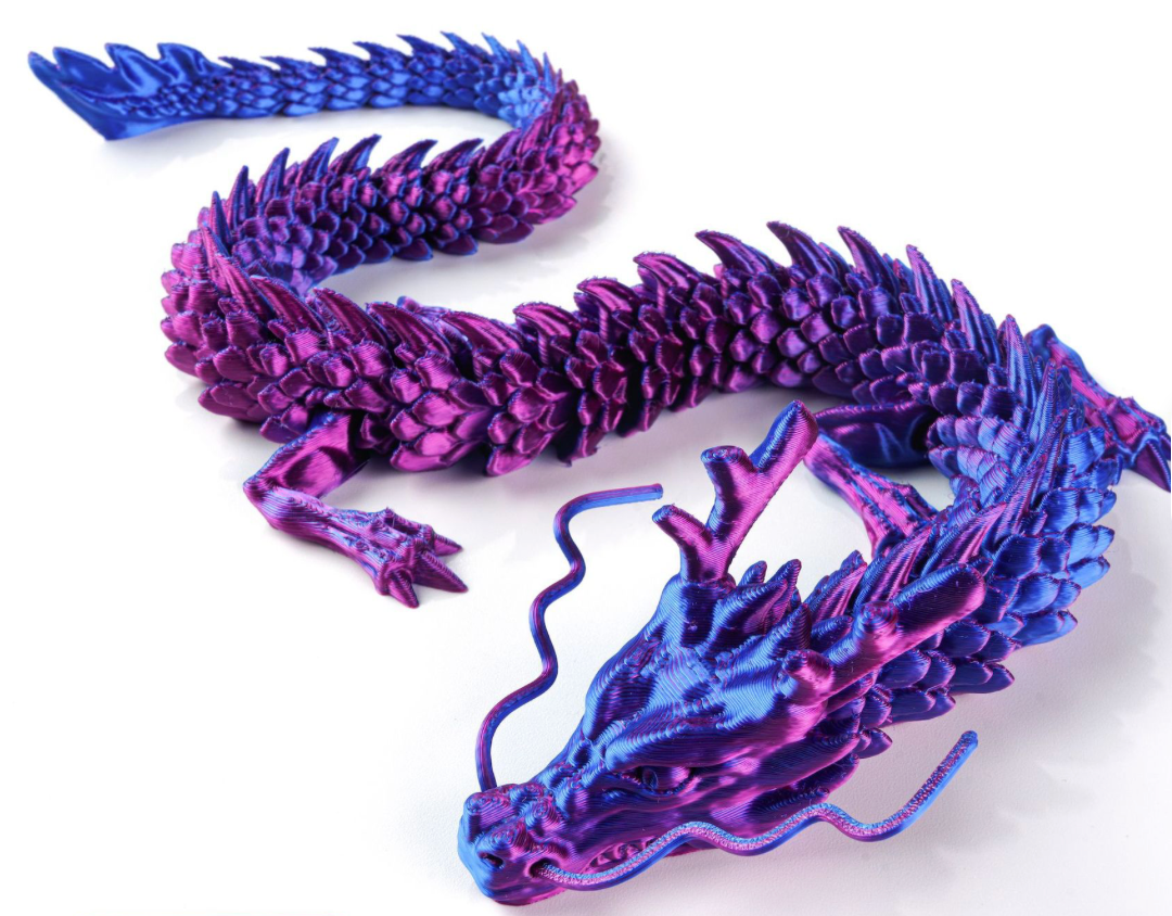 Purple and blue dragon figurine on a white background