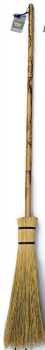 Traditional broom with a long handle and bristle head on a white background