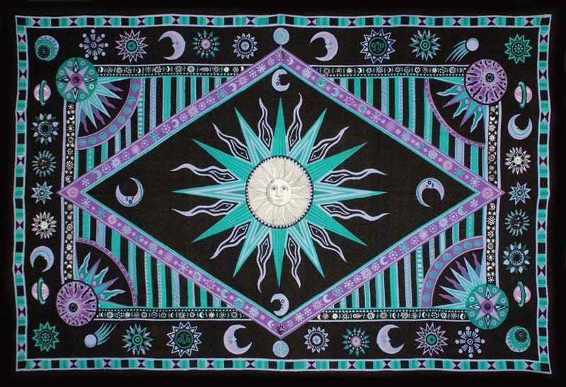 A square black tapestry or wall hanging featuring a central sun motif surrounded by geometric and celestial patterns in teal, purple, pink, and white.