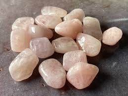 Collection of pink stones on a dark surface