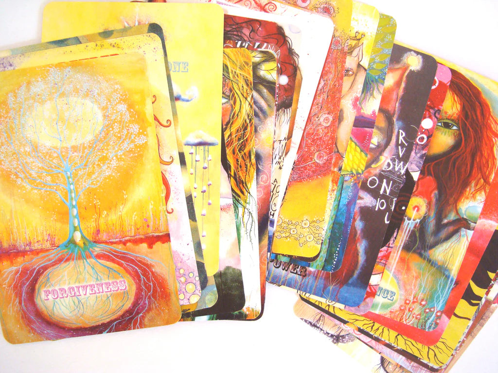 Colorful tarot cards with artistic designs on a white background