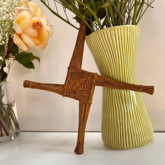 Brigid's cross with a vase and a flower