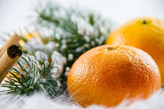 Image of oranges and pine on a white background