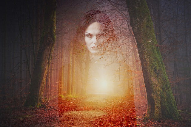 Female image ghosted over a forest