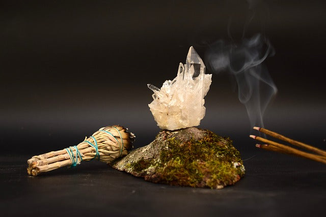 Smudge incense sticks and a crystal