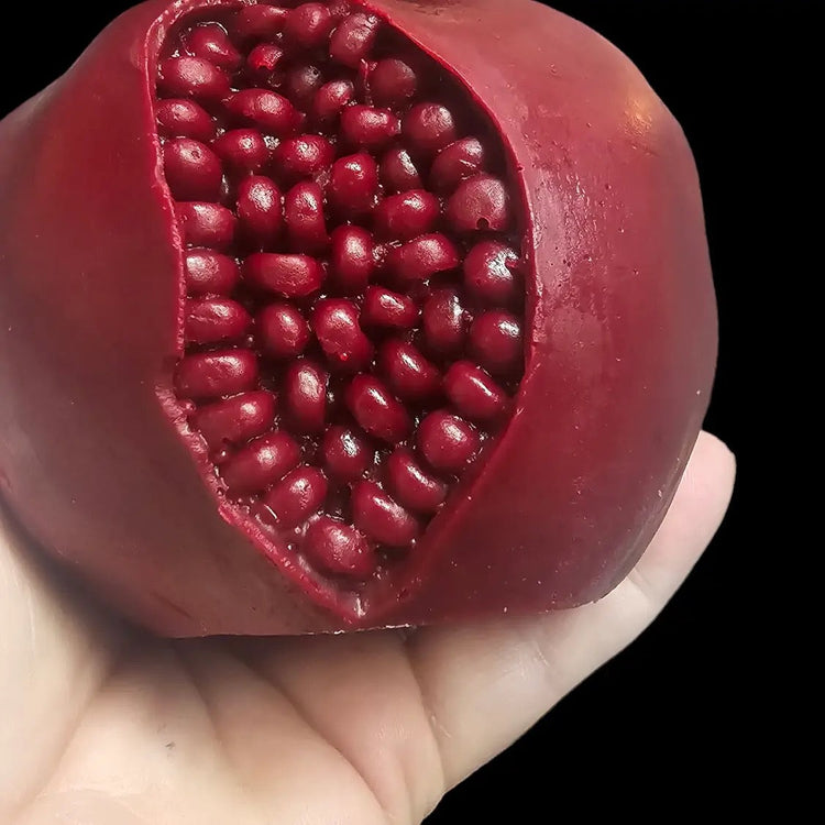 Pomegranate candle in a hand